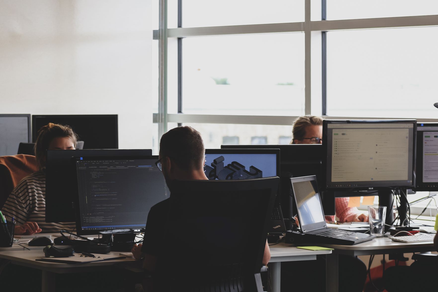 people working on computer in an office